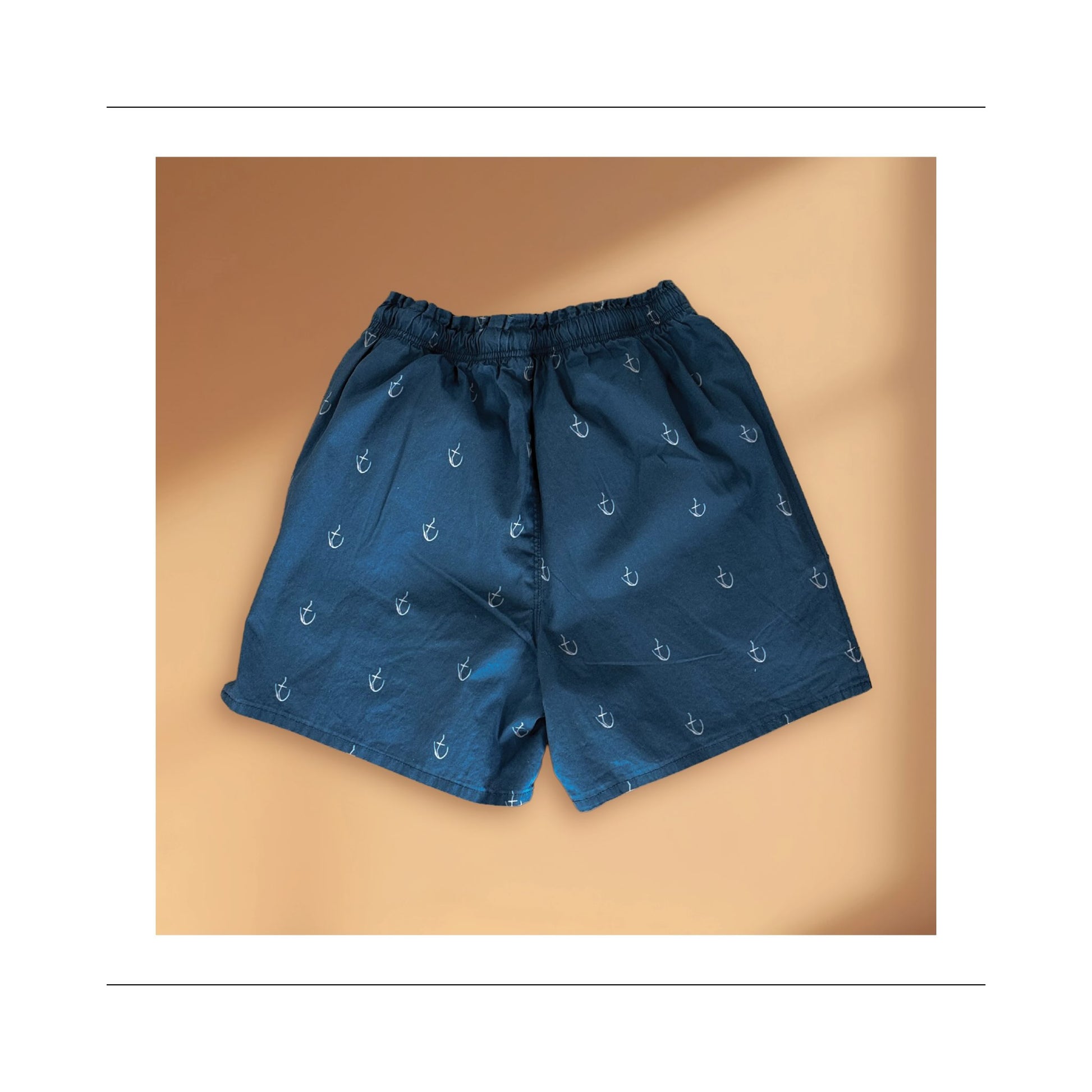 Boy and men mid thigh short back view sewing pattern with side pockets, leg slits for movement, elastic and cord tie waist