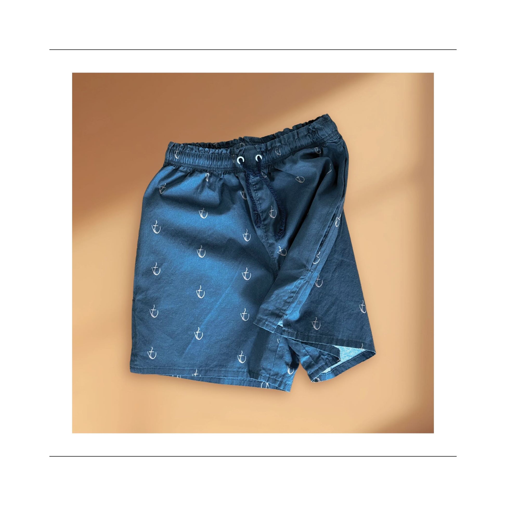 Boy and men mid-thigh short sewing pattern side view of pockets, leg slits for movement, elastic and cord tie waist